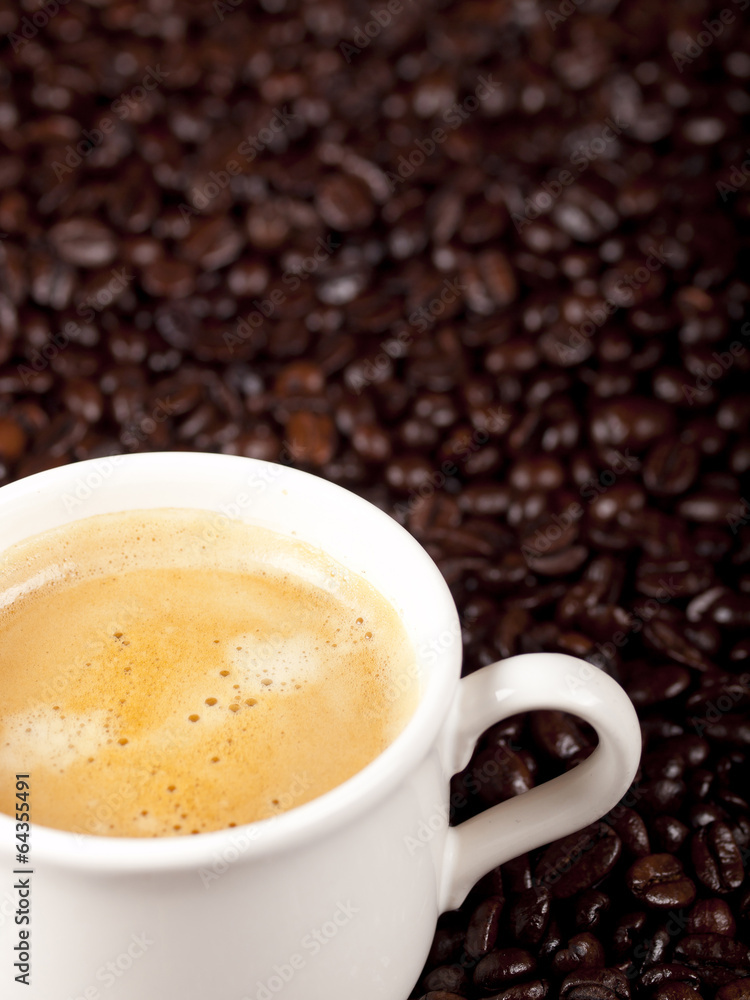 Fresh cup of dark roasted coffee with coffeebeans Fresh cup of dark roasted coffee with coffeebeans