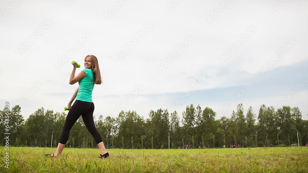 Woman With Dumbbells in a Meadow Woman With Dumbbells in a Meadow
