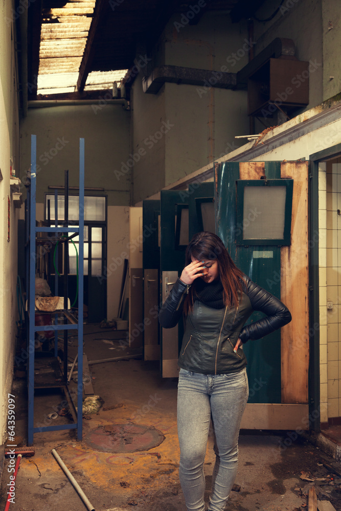 Young woman posing in industry abandoned