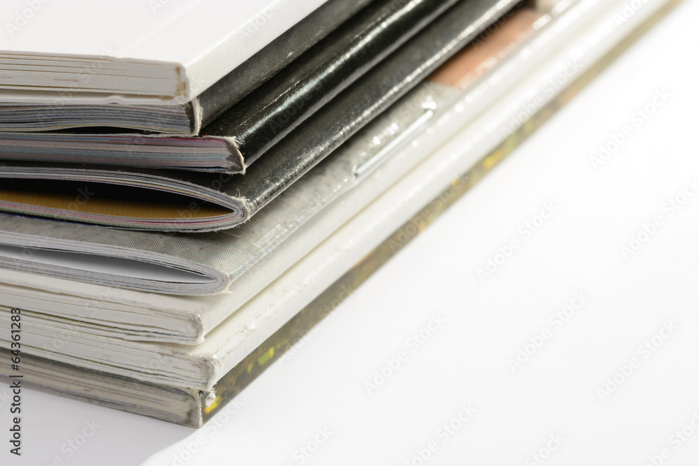 A pile of different catalogs on white background A pile of different catalogs on white background