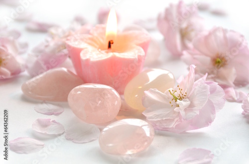gemstones with candle and flowers