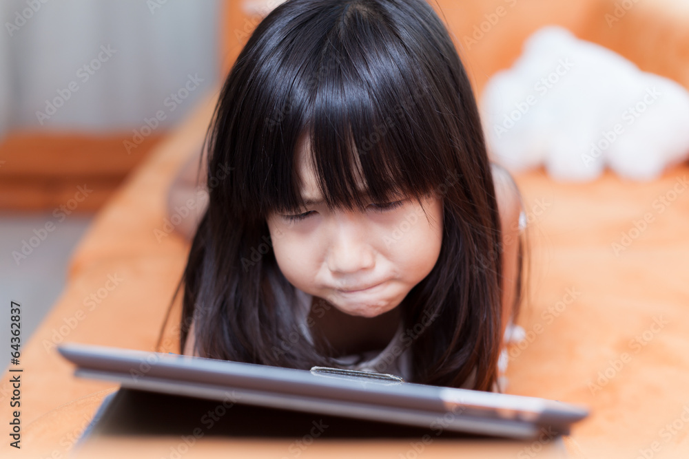 Girl playing with tablet. Girl playing with tablet.