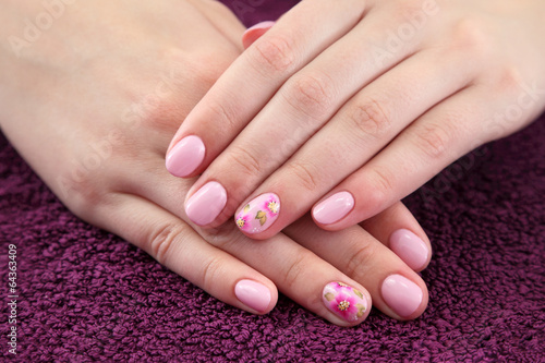Beauty treatment  hands with painted fingernails at towel