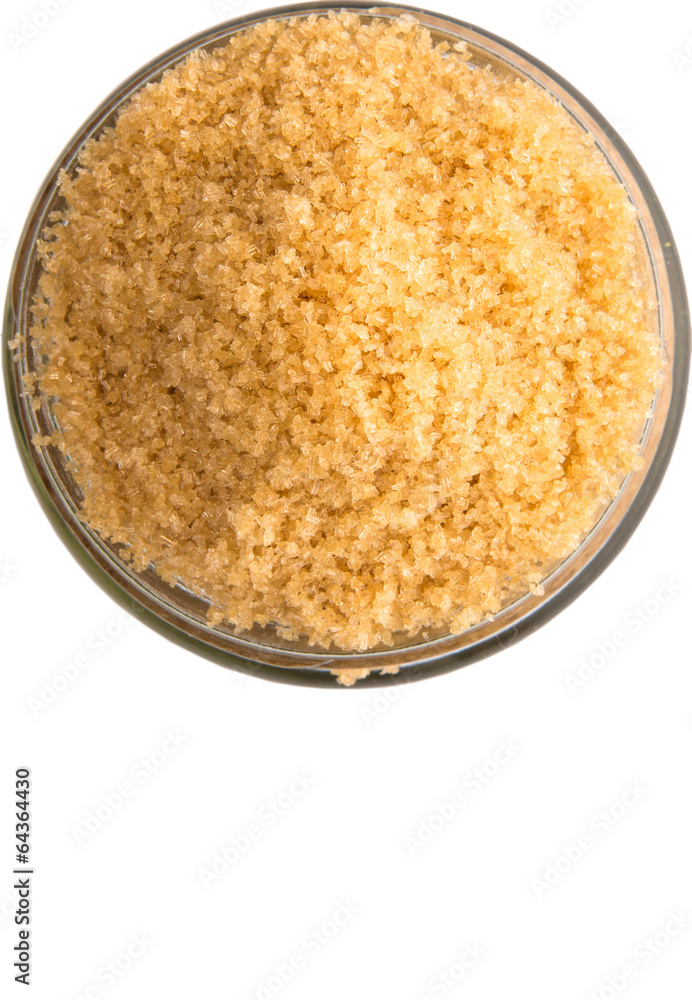 Brown sugar in a glass container over white background Brown sugar in a glass container over white background