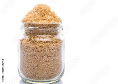 Brown sugar in a glass container over white background