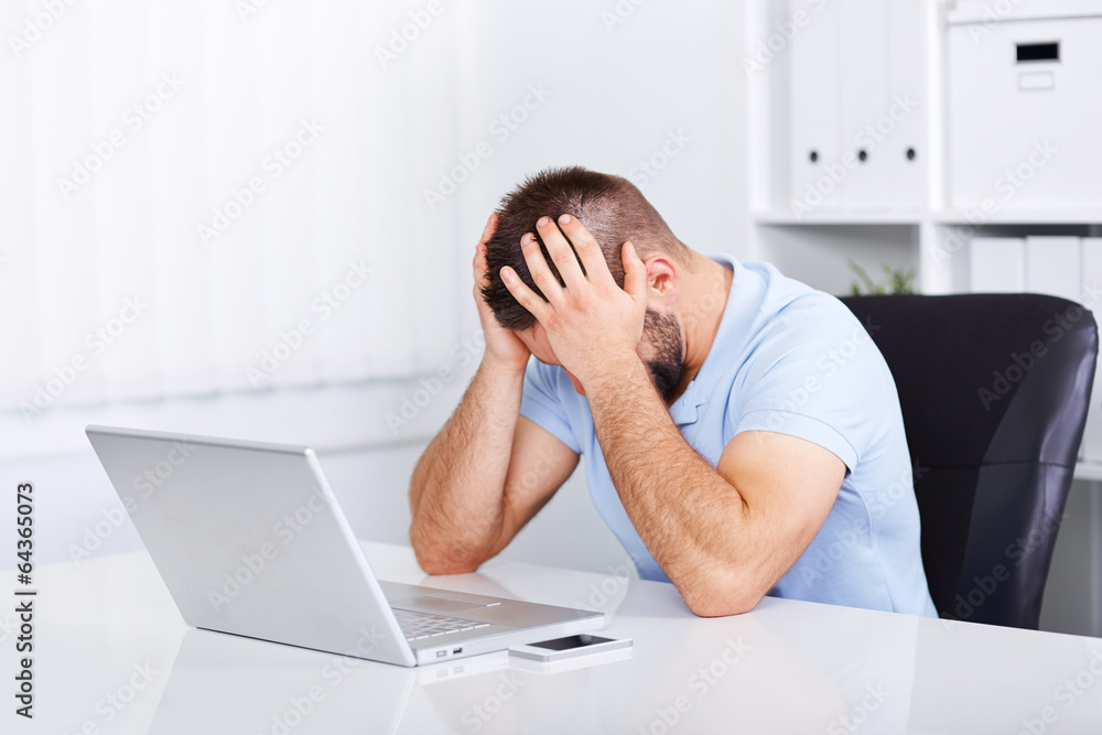 Young business man under stress with headache Young business man under stress with headache