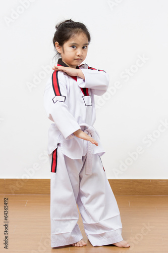 Little asian taekwondo child in fighting action