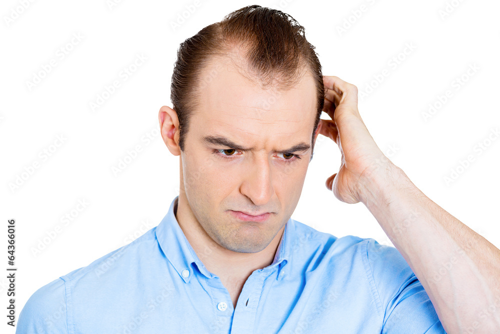 Headshot worried man scratching head remembering something Headshot worried man scratching head remembering something
