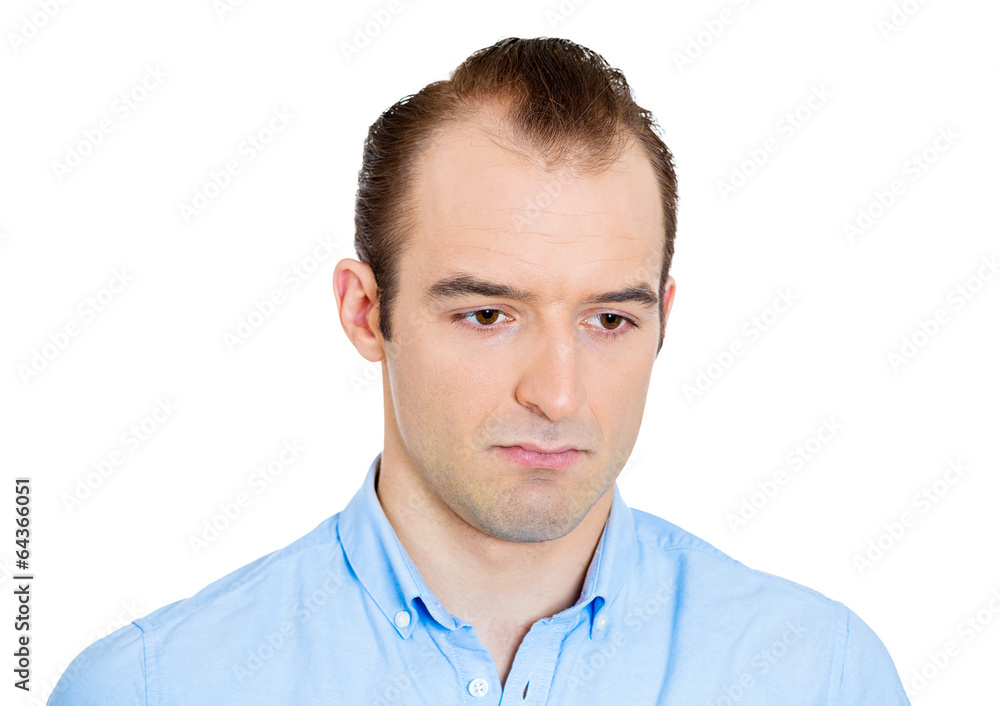 Headshot sad gloomy man deep in thought looking down Headshot sad gloomy man deep in thought looking down
