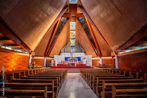 Interior of large modern catholic cathedral with high wooden cei