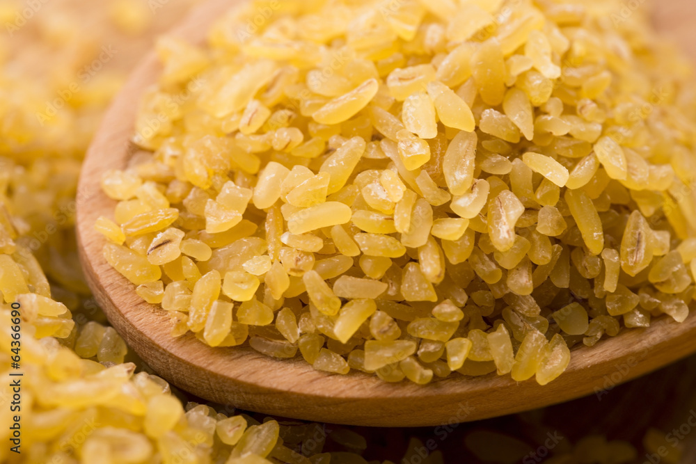 bulgur wheat in wooden spoon bulgur wheat in wooden spoon