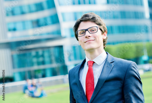 Outdoor portrait of a dynamic junior executive smiling