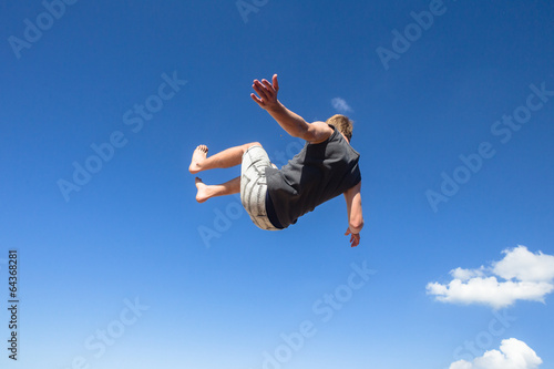 Boy Jumping Somersaults Blue Sky