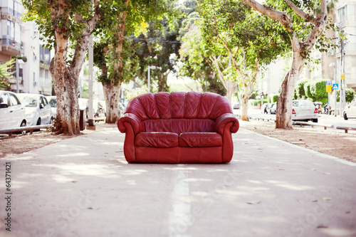 red vintage leather sofa on the street