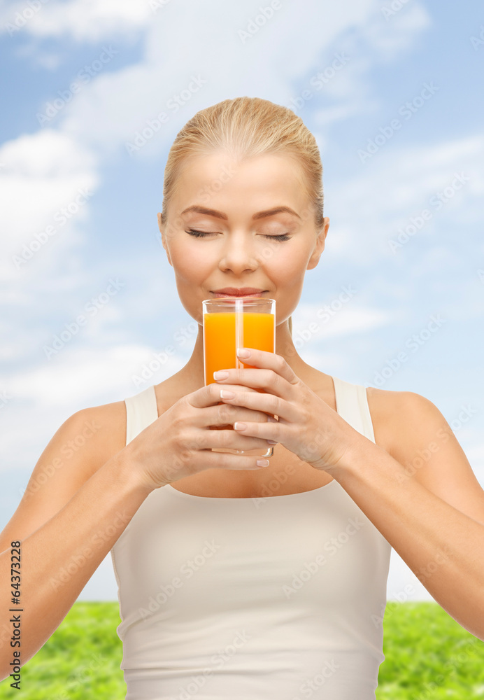 young woman drinking orange juice young woman drinking orange juice