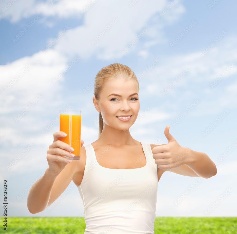 smiling woman holding glass of orange juice smiling woman holding glass of orange juice
