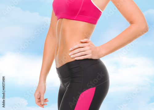 close up of female abs in sportswear