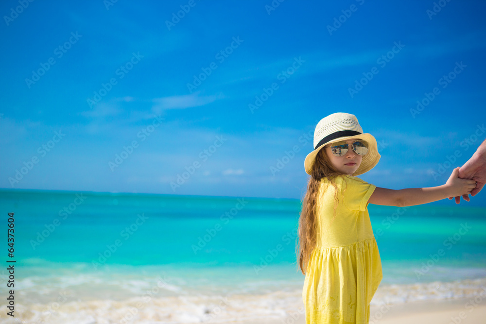 Adorable little girl in hat at beach during summer vacation Adorable little girl in hat at beach during summer vacation