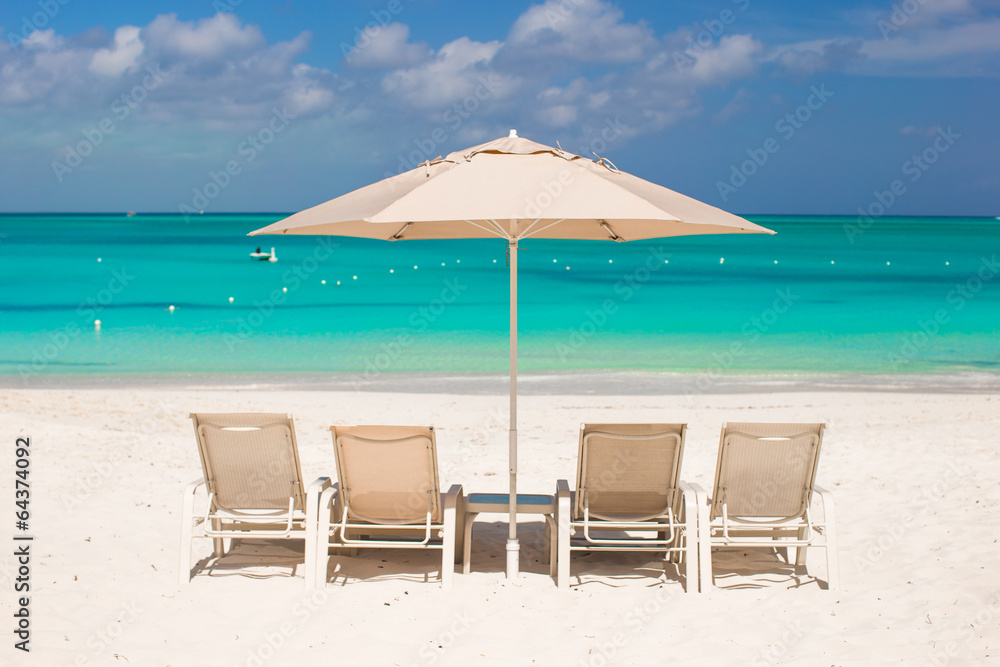 White umbrellas and sunbeds at tropical beach White umbrellas and sunbeds at tropical beach