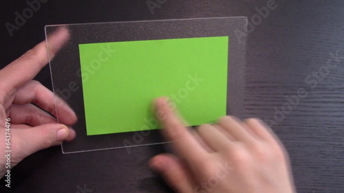 Woman uses a transparent tablet PC at his desk, green screen