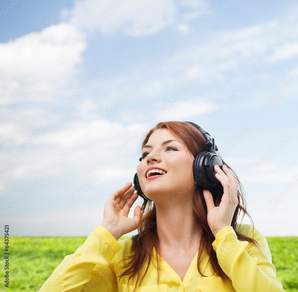 smiling young girl in headphones at home smiling young girl in headphones at home