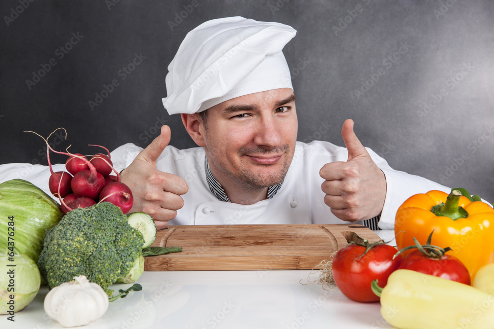Young chef with OK sign and vegetable