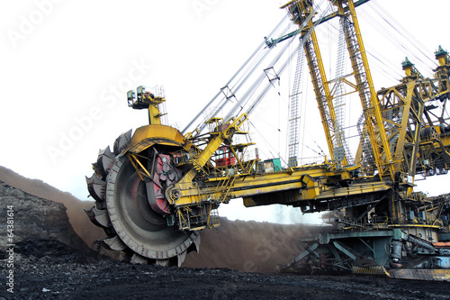 huge yellow  coal excavator in action