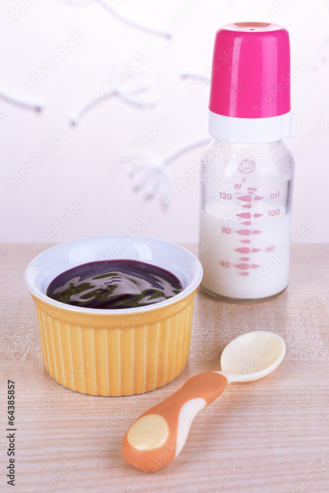 Baby food and milk on table on light background Baby food and milk on table on light background