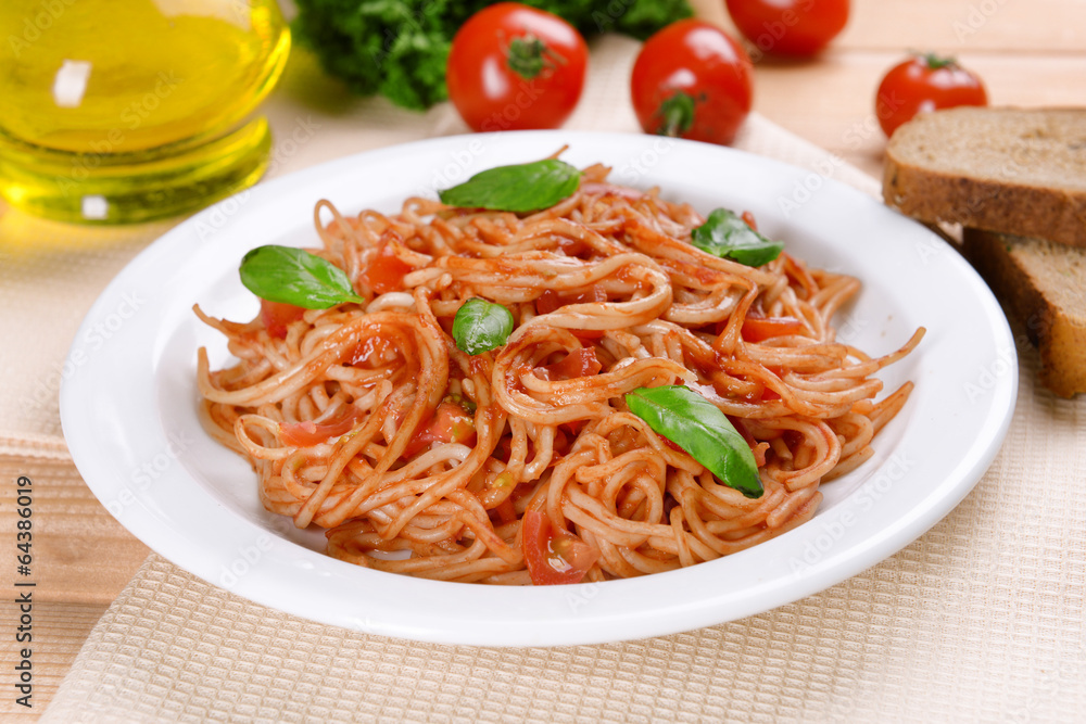Pasta with tomato sauce on plate on table close-up Pasta with tomato sauce on plate on table close-up