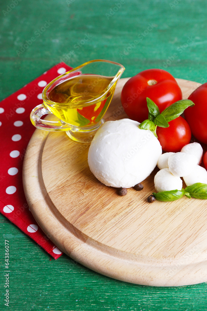 Composition with tasty mozzarella cheese balls, basil and red