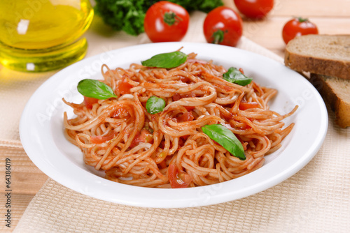 Pasta with tomato sauce on plate on table close-up