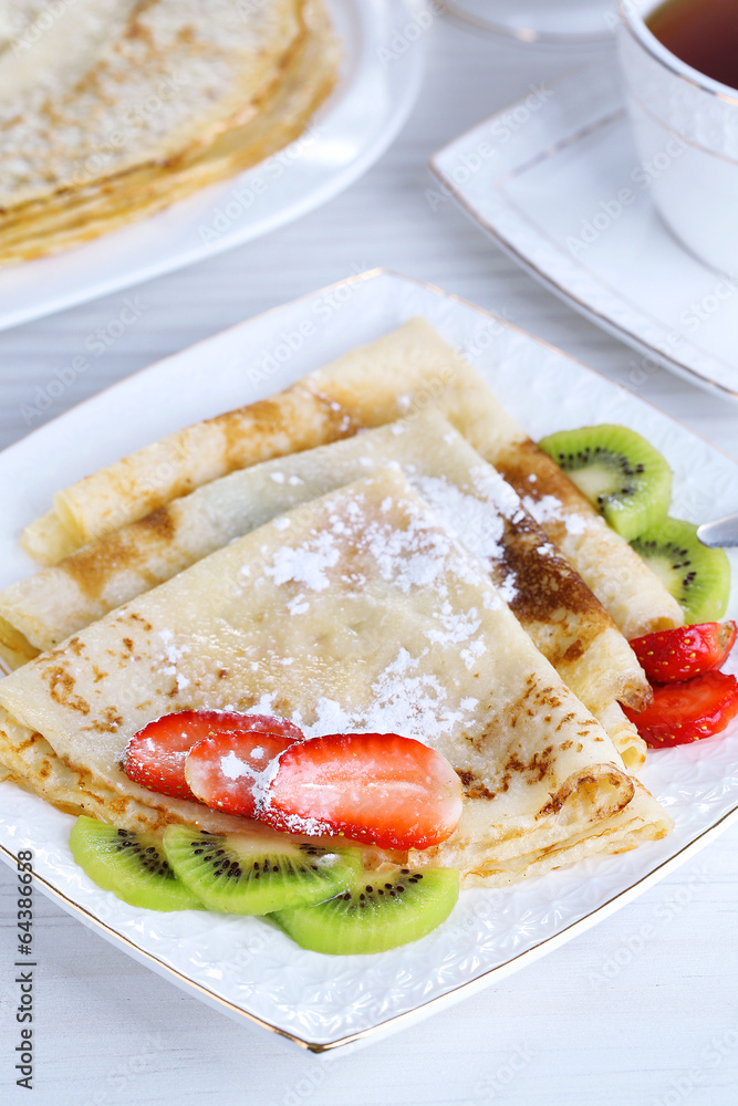 Delicious pancakes with strawberries and chocolate Delicious pancakes with strawberries and chocolate