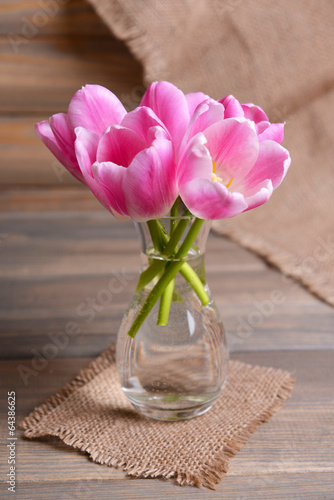 Fototapeta Naklejka Na Ścianę i Meble -  Beautiful tulips in bucket in vase on table on grey background