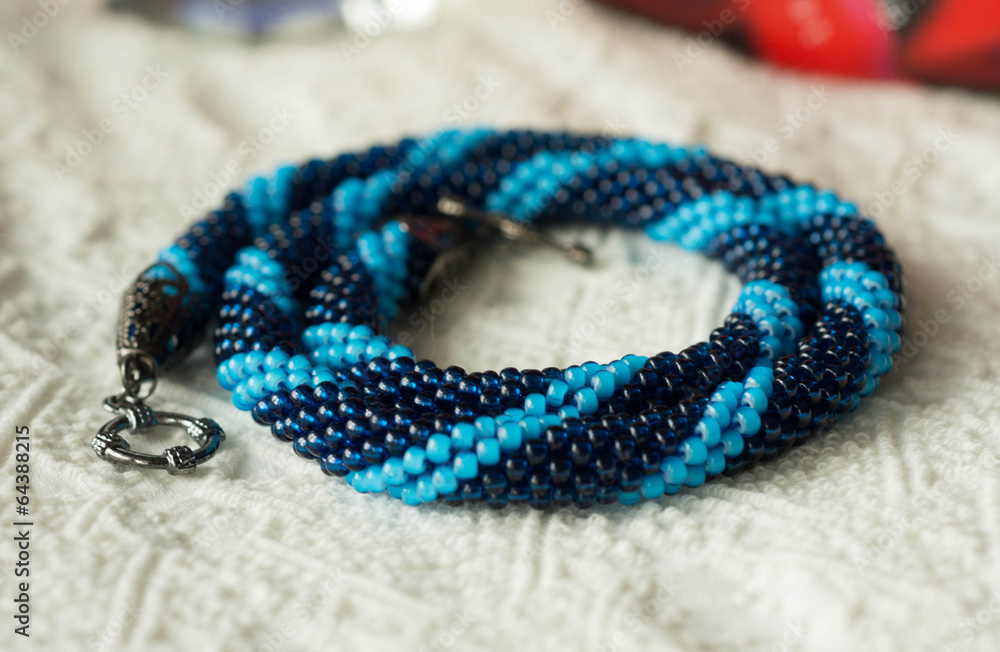 Knitted necklace from blue beads of two shades Knitted necklace from blue beads of two shades