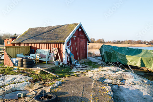 Leinwand Poster Covered boat and boathouse