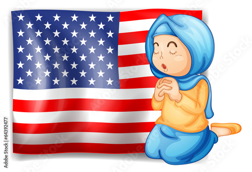 A Muslim praying in front of the USA flag