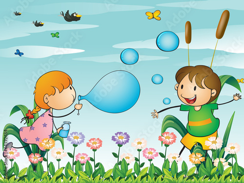 Kids at the garden playing with the blowing bubbles