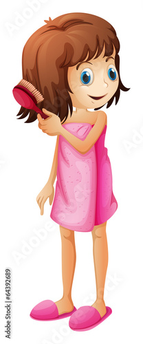 A young girl combing her hair