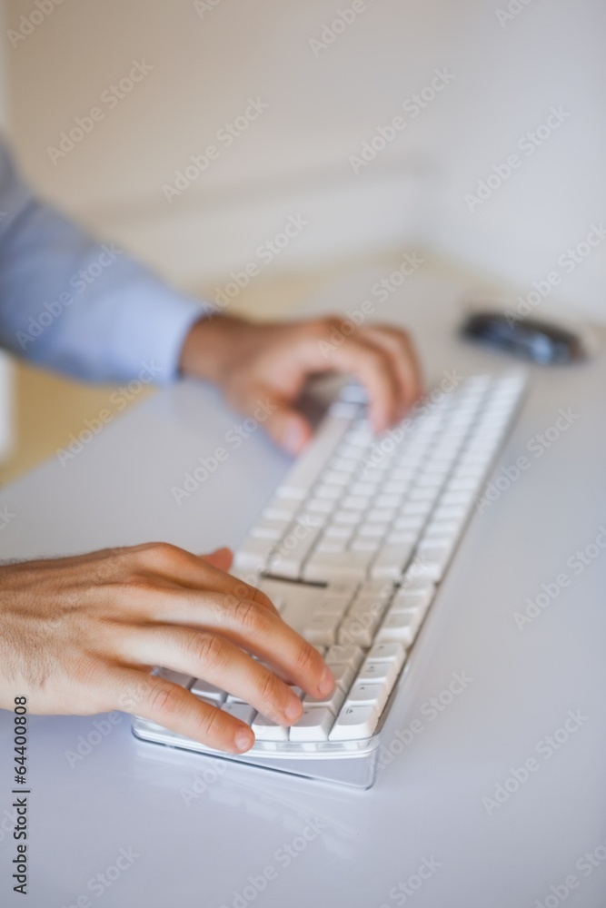 Businessman typing on keyboard at desk Businessman typing on keyboard at desk