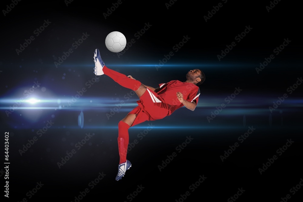 Composite image of football player in red kicking