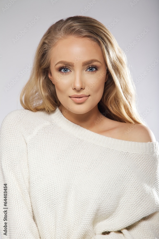 Sensual young female model posing on grey background Sensual young female model posing on grey background