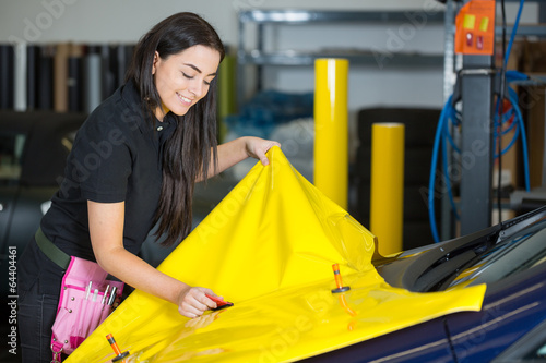 Car wrapping specialists straightening vinyl foil or film