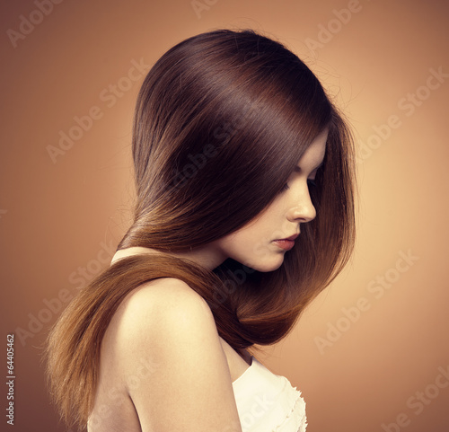 Close-up of young model with glossy straight brown hair #64405462