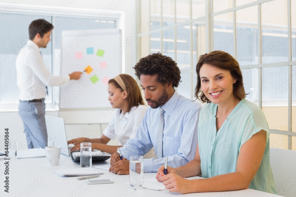 Businesswoman with colleagues in boardroom meeting Businesswoman with colleagues in boardroom meeting