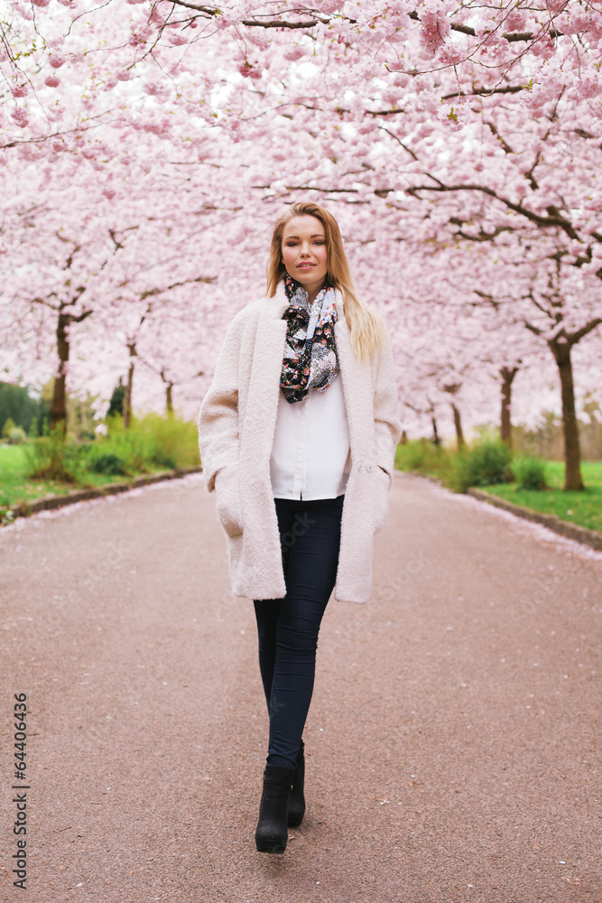 Stylish young woman at spring blossom park Stylish young woman at spring blossom park
