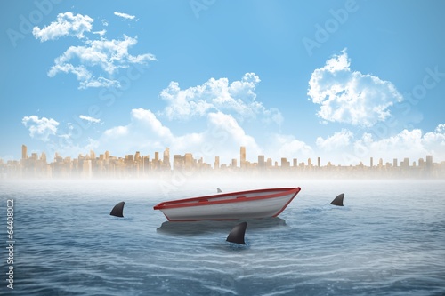 Sharks circling a small boat in the sea © WavebreakMediaMicro