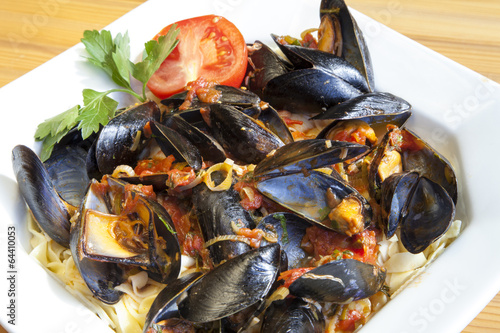 Pasta with Mediterranean mussels in tomato sauce with herbs