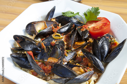 Pasta with Mediterranean mussels in tomato sauce with herbs