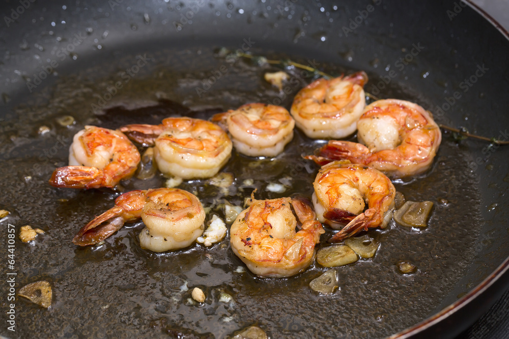 cooking shrimp in a pan cooking shrimp in a pan