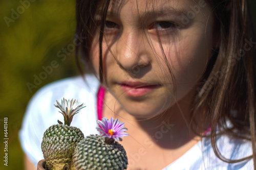 Maedchen mit 2 Kakteen im Fruehling photo